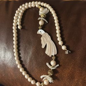 Vintage pearl necklace with mother of pearl inlay of a parrot.